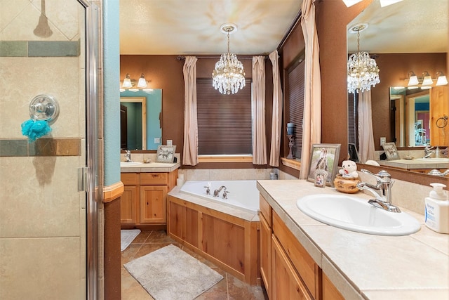 bathroom featuring tile patterned flooring, a notable chandelier, vanity, and shower with separate bathtub