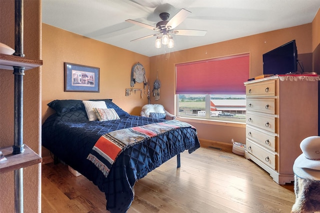 bedroom featuring ceiling fan and light hardwood / wood-style floors