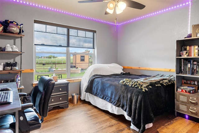 bedroom with ceiling fan and hardwood / wood-style floors