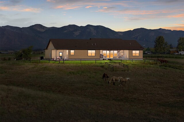 back house at dusk featuring a mountain view