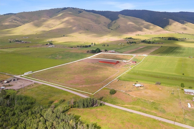 birds eye view of property with a mountain view and a rural view