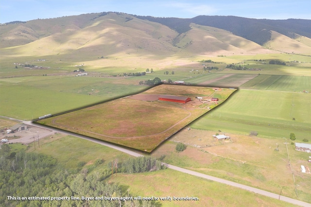 drone / aerial view featuring a rural view and a mountain view