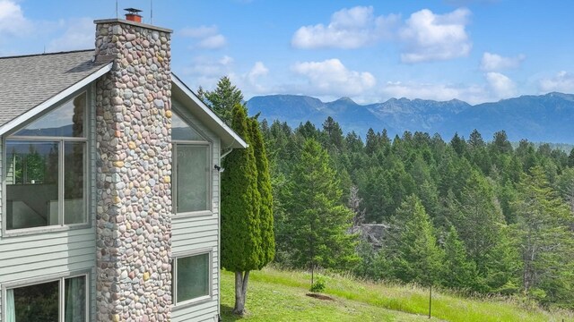 253 Pine Needle Ln, Bigfork, MT 59911 - view of mountain backdrop featuring a forest