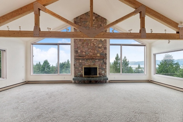 253 Pine Needle Ln, Bigfork, MT 59911 - unfurnished living room featuring high vaulted ceiling, beam ceiling, plenty of natural light, carpet flooring, and a stone fireplace