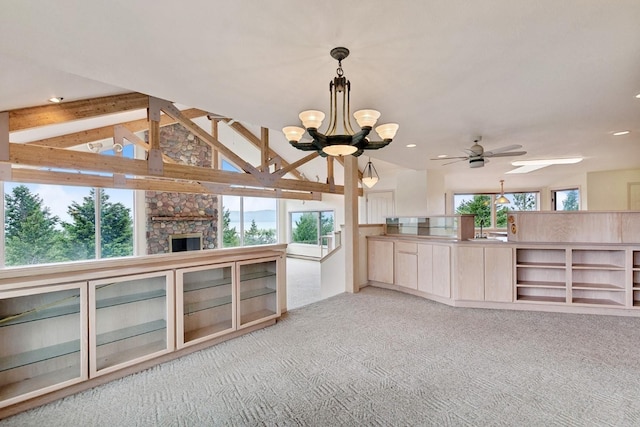 253 Pine Needle Ln, Bigfork, MT 59911 - unfurnished living room with plenty of natural light, light carpet, a chandelier, recessed lighting, and a fireplace