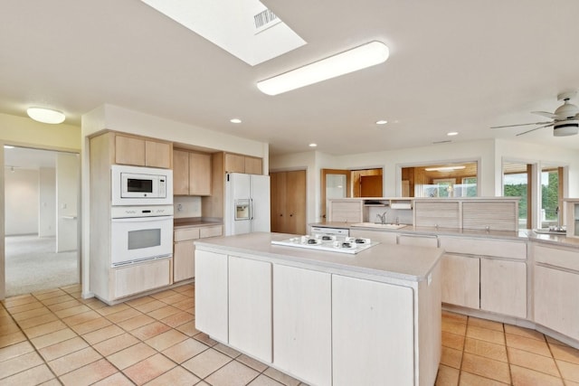 253 Pine Needle Ln, Bigfork, MT 59911 - kitchen featuring white appliances, light tile patterned flooring, light brown cabinets, light countertops, and recessed lighting