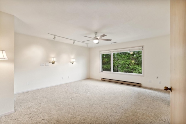 253 Pine Needle Ln, Bigfork, MT 59911 - carpeted spare room featuring baseboard heating, ceiling fan, and track lighting