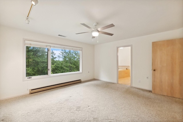 unfurnished bedroom featuring visible vents, ensuite bathroom, baseboard heating, carpet floors, and track lighting