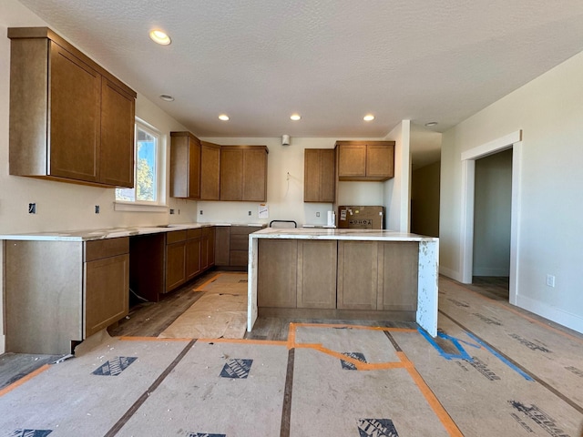 kitchen featuring a textured ceiling and a center island