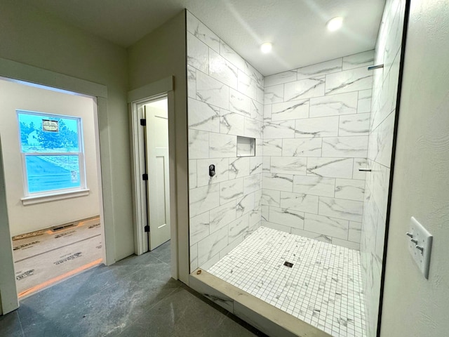 bathroom with tiled shower