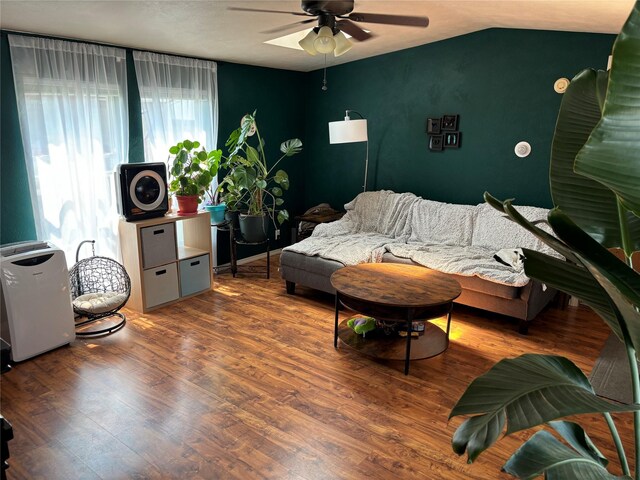 living room featuring hardwood / wood-style flooring, lofted ceiling, and ceiling fan