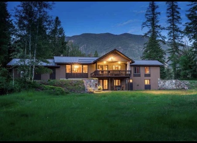 2378 Lake Creek Rd, Troy, MT 59935 - rear view of property featuring a lawn and a deck with mountain view