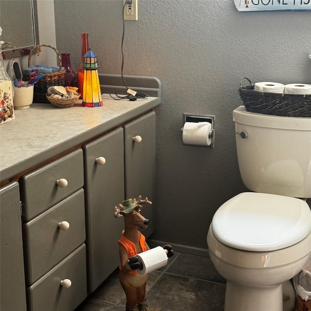 2378 Lake Creek Rd, Troy, MT 59935 - half bathroom featuring vanity, toilet, baseboards, and tile patterned floors