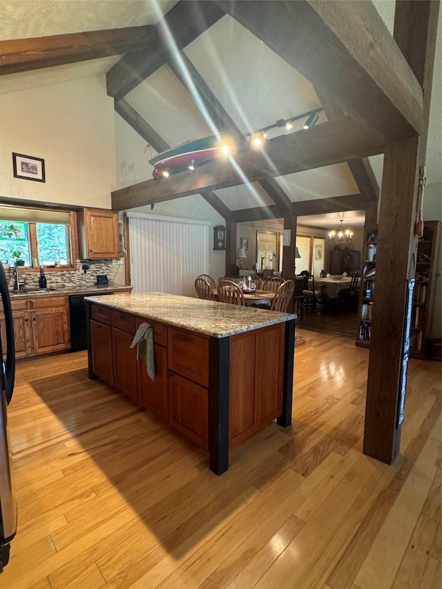 2378 Lake Creek Rd, Troy, MT 59935 - kitchen with light wood finished floors, a center island, a chandelier, brown cabinetry, and open floor plan