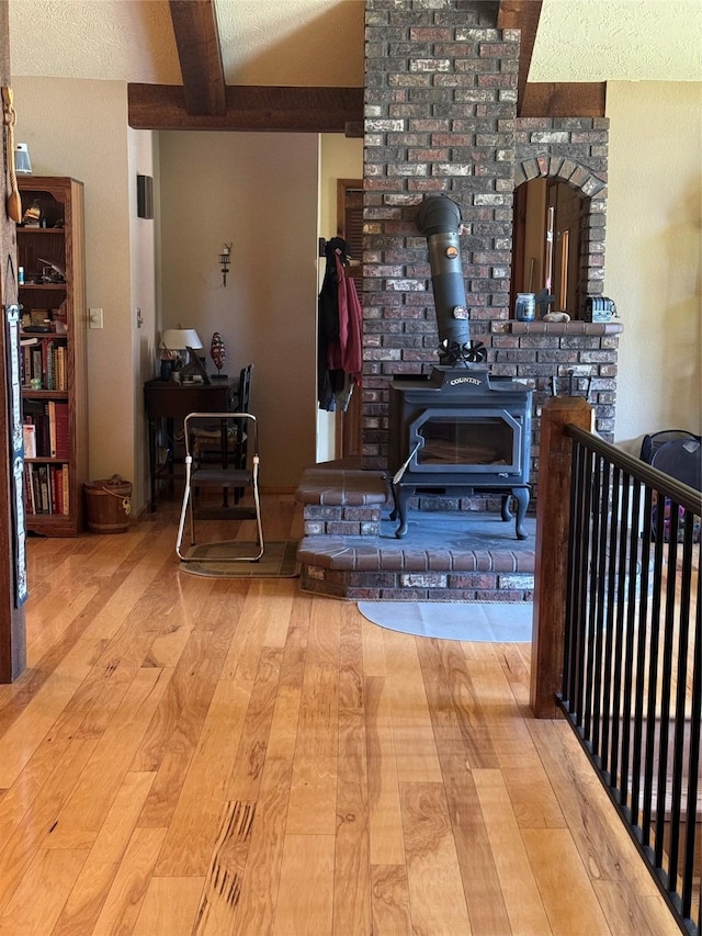2378 Lake Creek Rd, Troy, MT 59935 - kitchen featuring beamed ceiling, hardwood / wood-style floors, and a wood stove