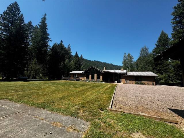 2378 Lake Creek Rd, Troy, MT 59935 - single story home with a front lawn, metal roof, and a forest view
