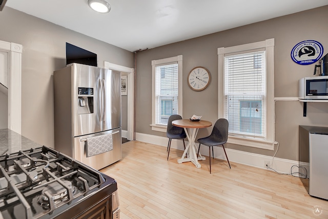 kitchen featuring a healthy amount of sunlight, light hardwood / wood-style flooring, and appliances with stainless steel finishes