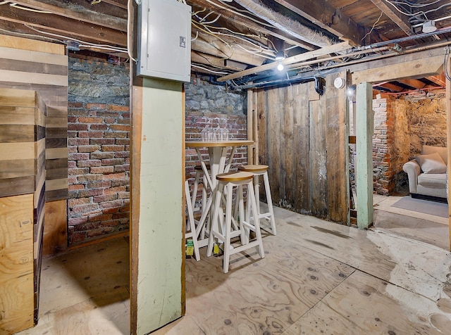 basement featuring brick wall