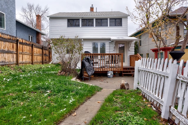 rear view of house featuring a wooden deck