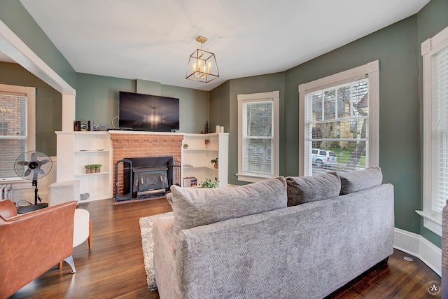 living room with dark hardwood / wood-style floors and a brick fireplace