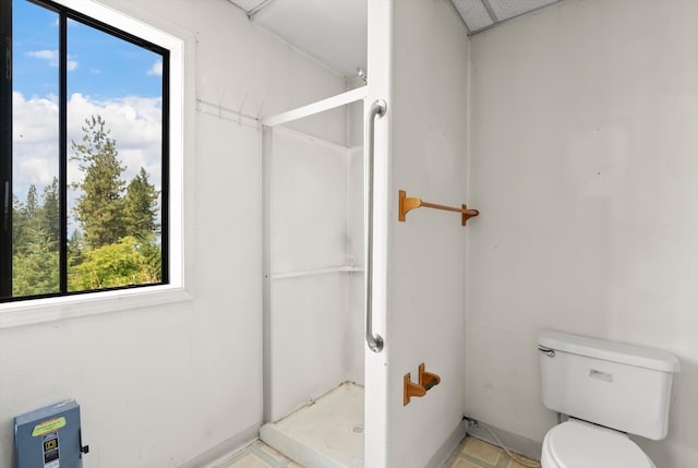 bathroom with toilet and walk in shower