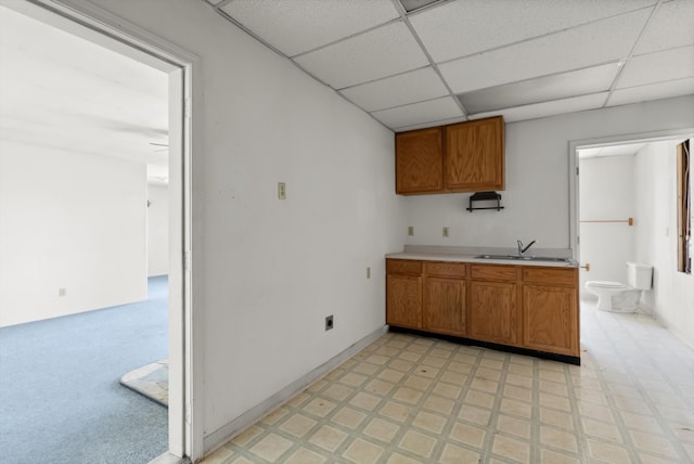 kitchen featuring a paneled ceiling and sink