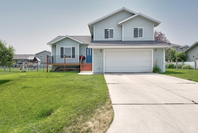 view of front of home featuring a front lawn, a deck, and a garage