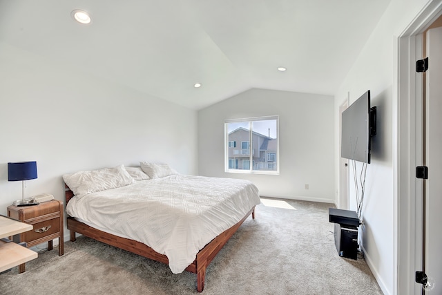 carpeted bedroom featuring lofted ceiling