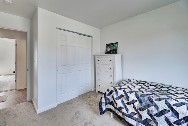 bedroom featuring a closet and light colored carpet