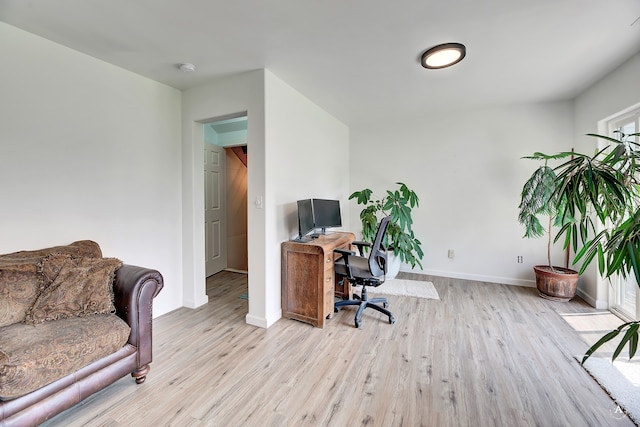 office with light hardwood / wood-style floors