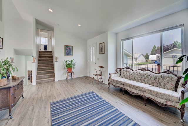 living room featuring vaulted ceiling and light hardwood / wood-style floors