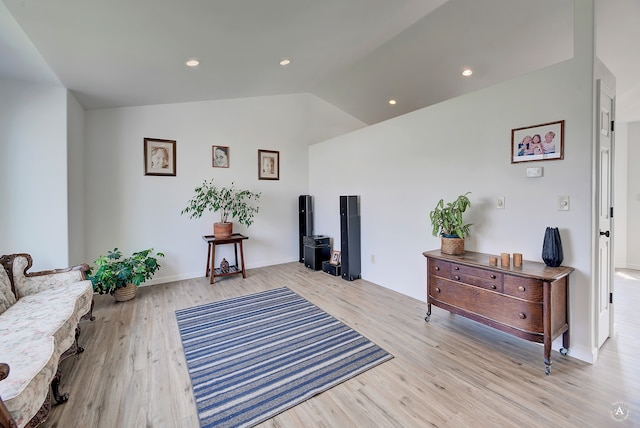 living area featuring light hardwood / wood-style flooring and vaulted ceiling