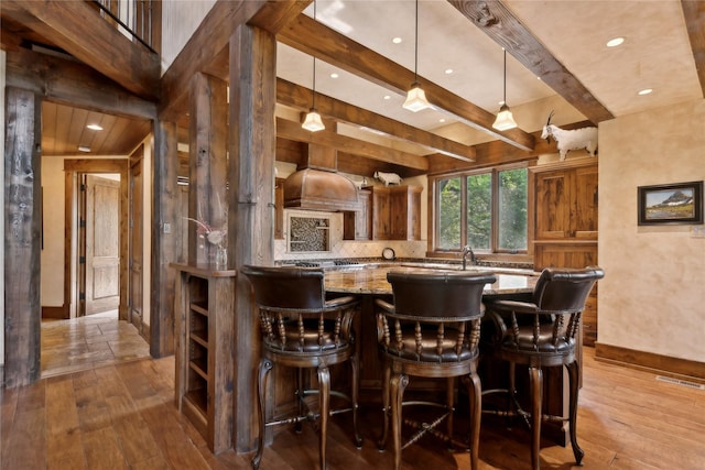 bar with hardwood / wood-style flooring, visible vents, backsplash, and beam ceiling