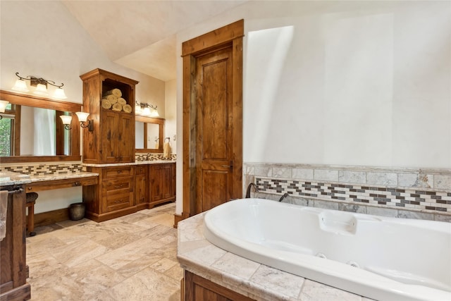 bathroom featuring a whirlpool tub and vanity