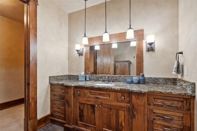 bathroom featuring baseboards and vanity