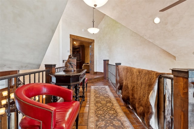 interior space featuring lofted ceiling and an upstairs landing