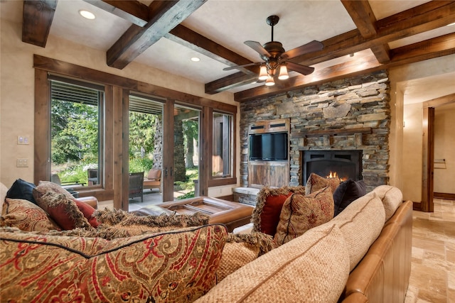 living area with coffered ceiling, beamed ceiling, and a stone fireplace