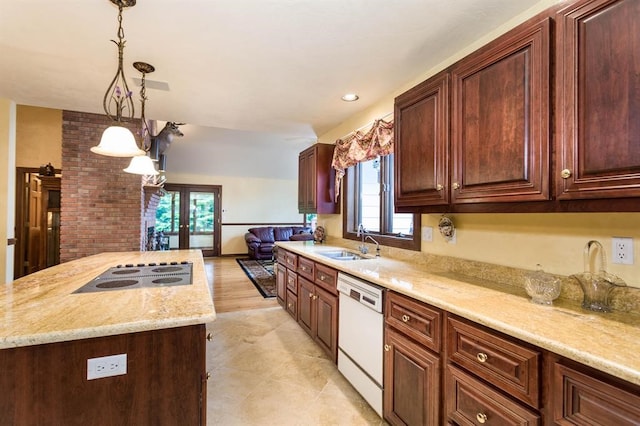 kitchen with sink, white appliances, a healthy amount of sunlight, and decorative light fixtures