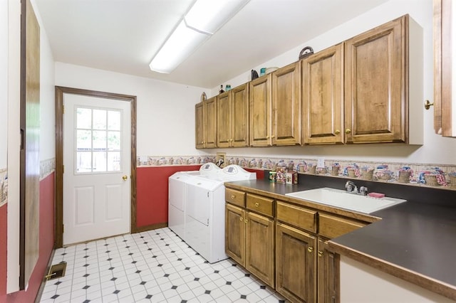 laundry room with sink, cabinets, light tile patterned floors, and separate washer and dryer