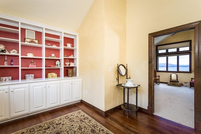 carpeted office with lofted ceiling