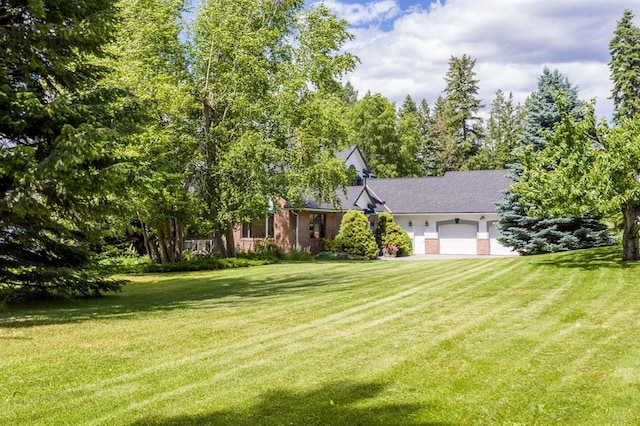 view of front facade with a garage and a front lawn