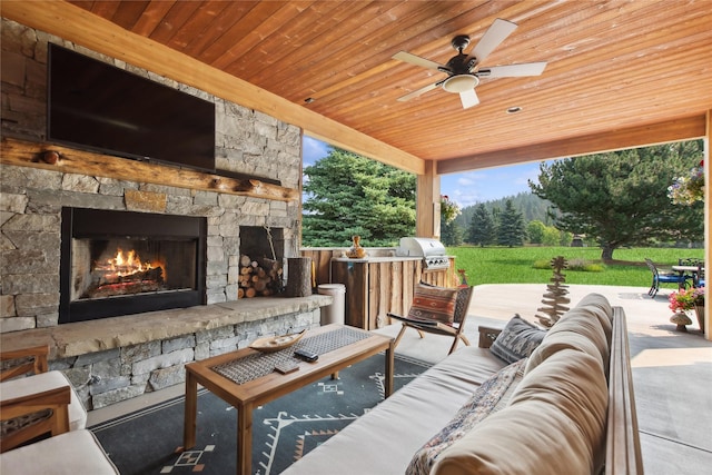 view of patio featuring area for grilling, an outdoor living space with a fireplace, an outdoor kitchen, and a ceiling fan