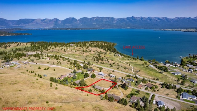 aerial view featuring a water and mountain view