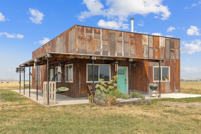 rear view of property featuring a yard