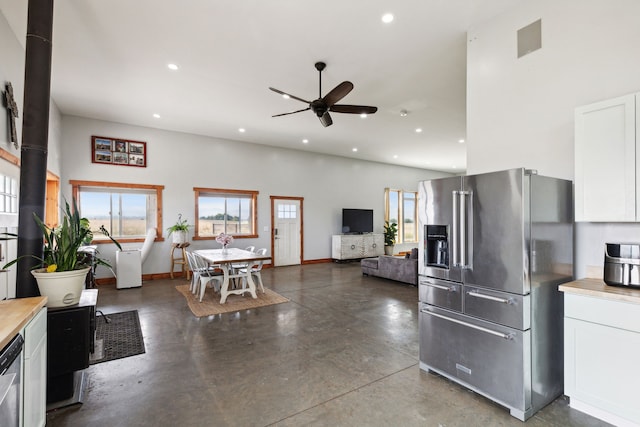 kitchen with white cabinets, ceiling fan, and stainless steel appliances