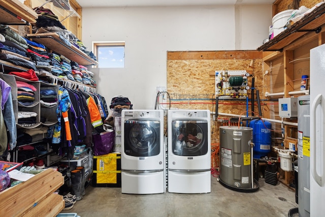 washroom with water heater and washer and dryer