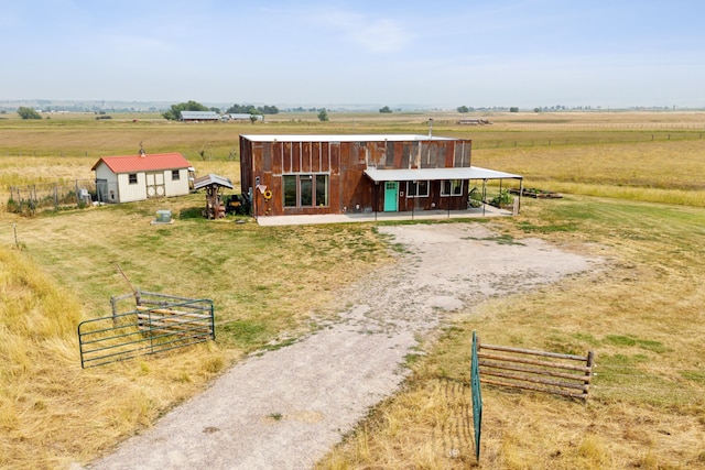 view of front of house with a rural view and an outbuilding