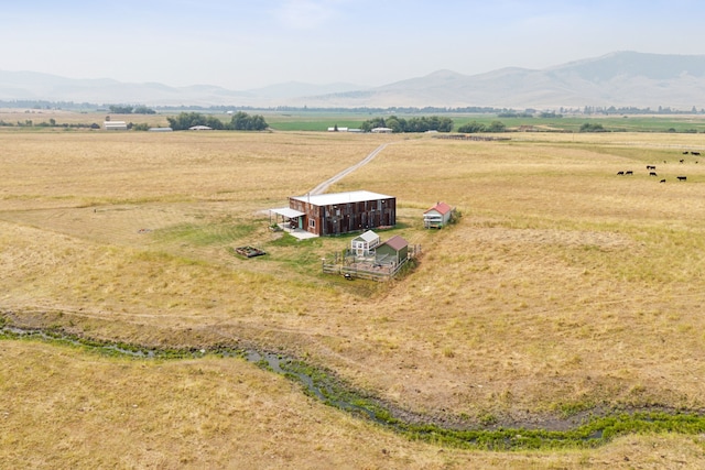 birds eye view of property with a mountain view and a rural view