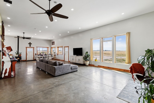 living room featuring concrete flooring and ceiling fan