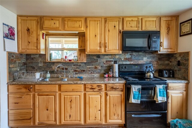 kitchen with decorative backsplash, light brown cabinetry, black appliances, and sink